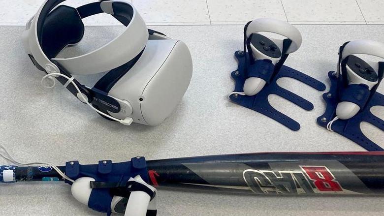 The virtual reality headset and controllers, including one attached to a bat, that are used for baseball and softball hitting practice using software available through the NCPA LaunchBox, 由365英国上市杜波依斯提供动力.